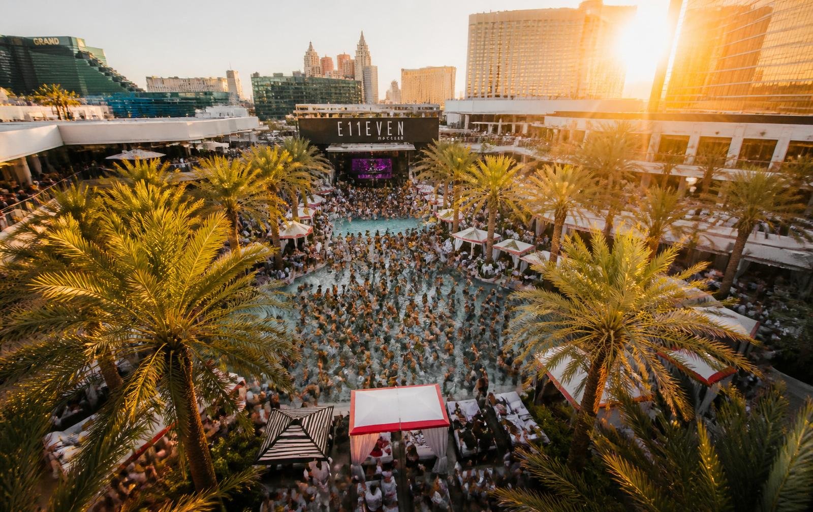 Aerial dayclub pool party at golden hour